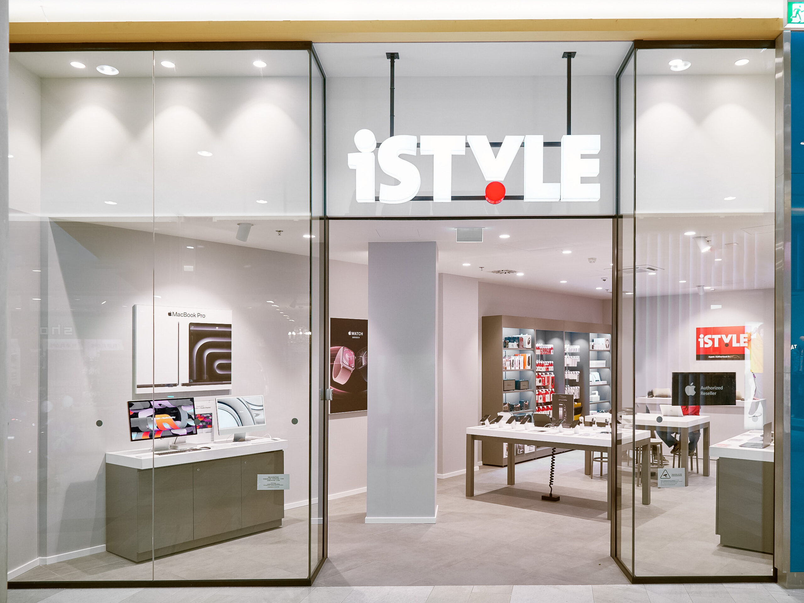 A modern retail store entrance with the sign "iSTYLE," showcasing Apple products and accessories inside.