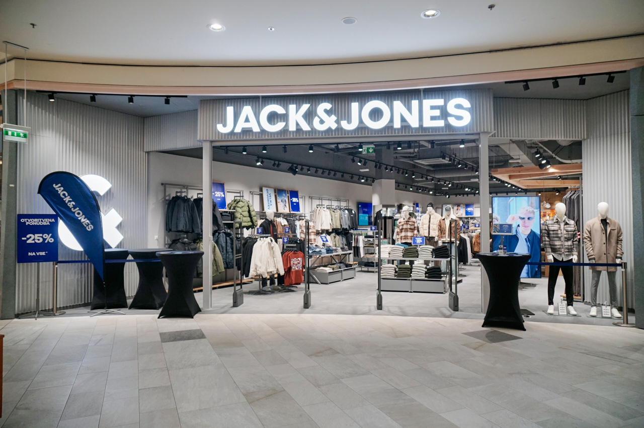 A storefront of a Jack & Jones clothing store featuring mannequins, clothing displays, and promotional signage.