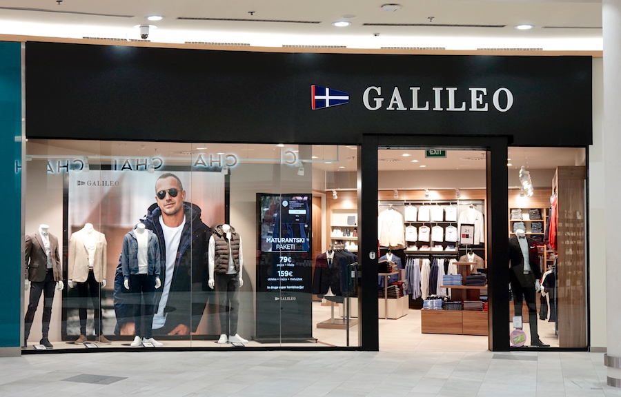 A clothing store named "GALILEO" featuring a large display with a model, showcasing various outfits in the window.