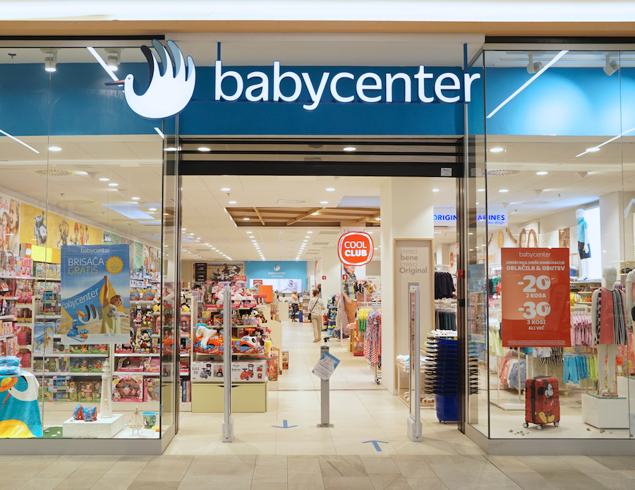 A storefront of a baby products store named "babycenter," featuring colorful displays of toys and clothing inside.