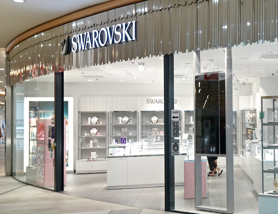 A Swarovski store entrance showcasing elegant jewelry displays and modern decor.