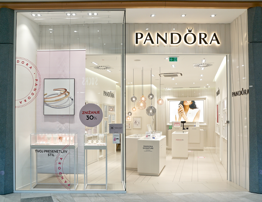 A stylish Pandora jewelry store featuring elegant displays, a promotional sign for 30% off, and modern lighting.