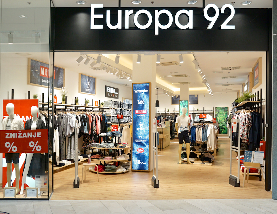 A clothing store named "Europa 92" featuring mannequins, racks of apparel, and promotional signage.