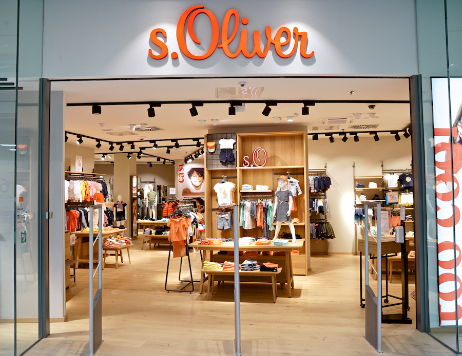 A storefront of s.Oliver featuring a variety of colorful clothing displays and a welcoming interior.