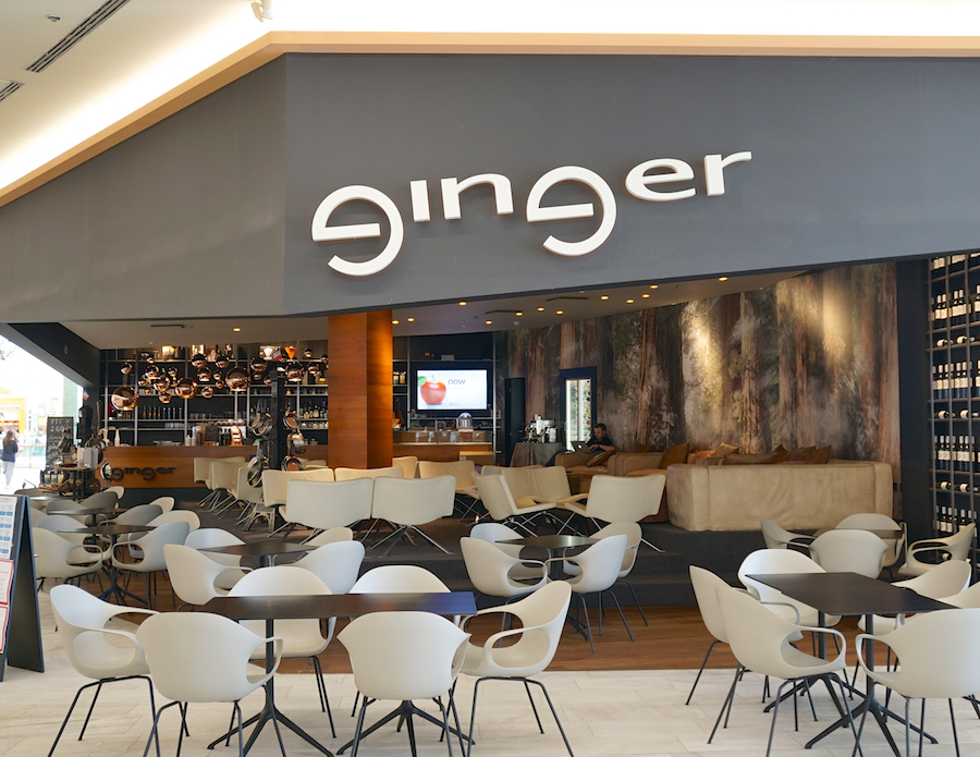 A modern café interior with the name "ginger" prominently displayed. Features stylish seating and a bar area.