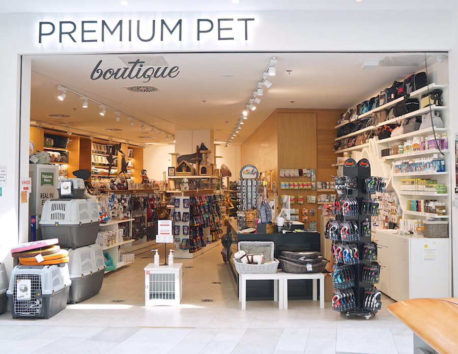 A pet boutique featuring various pet supplies, including toys, food, and accessories, with a bright and organized interior.