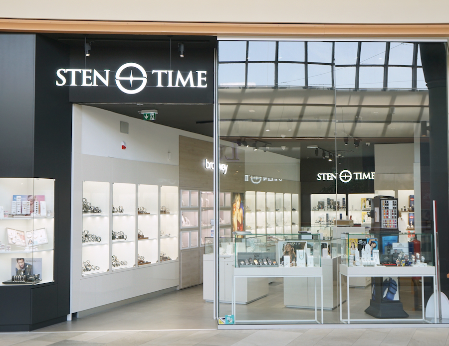 A jewelry store named "STEN TIME" with glass displays showcasing watches and accessories, located in a shopping mall.