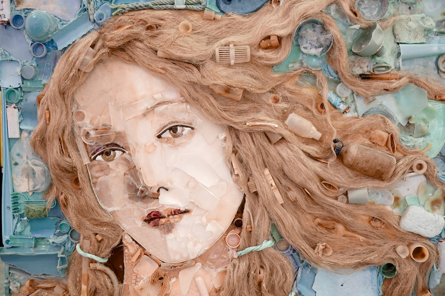 A portrait made from various plastic materials, depicting a woman's face with flowing hair, showcasing environmental art.