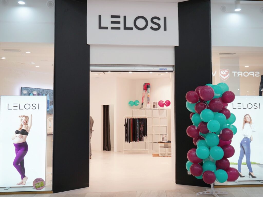 Storefront of "LELOSI" featuring promotional displays and colorful balloons. The interior is bright and inviting.